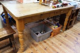 Pine two drawer farmhouse style kitchen table on turned legs, 77cm by 142cm by 106cm.