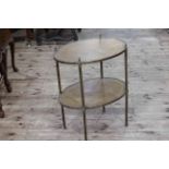 Oval brass and leather inset two tier table, 66cm by 54cm by 39cm.