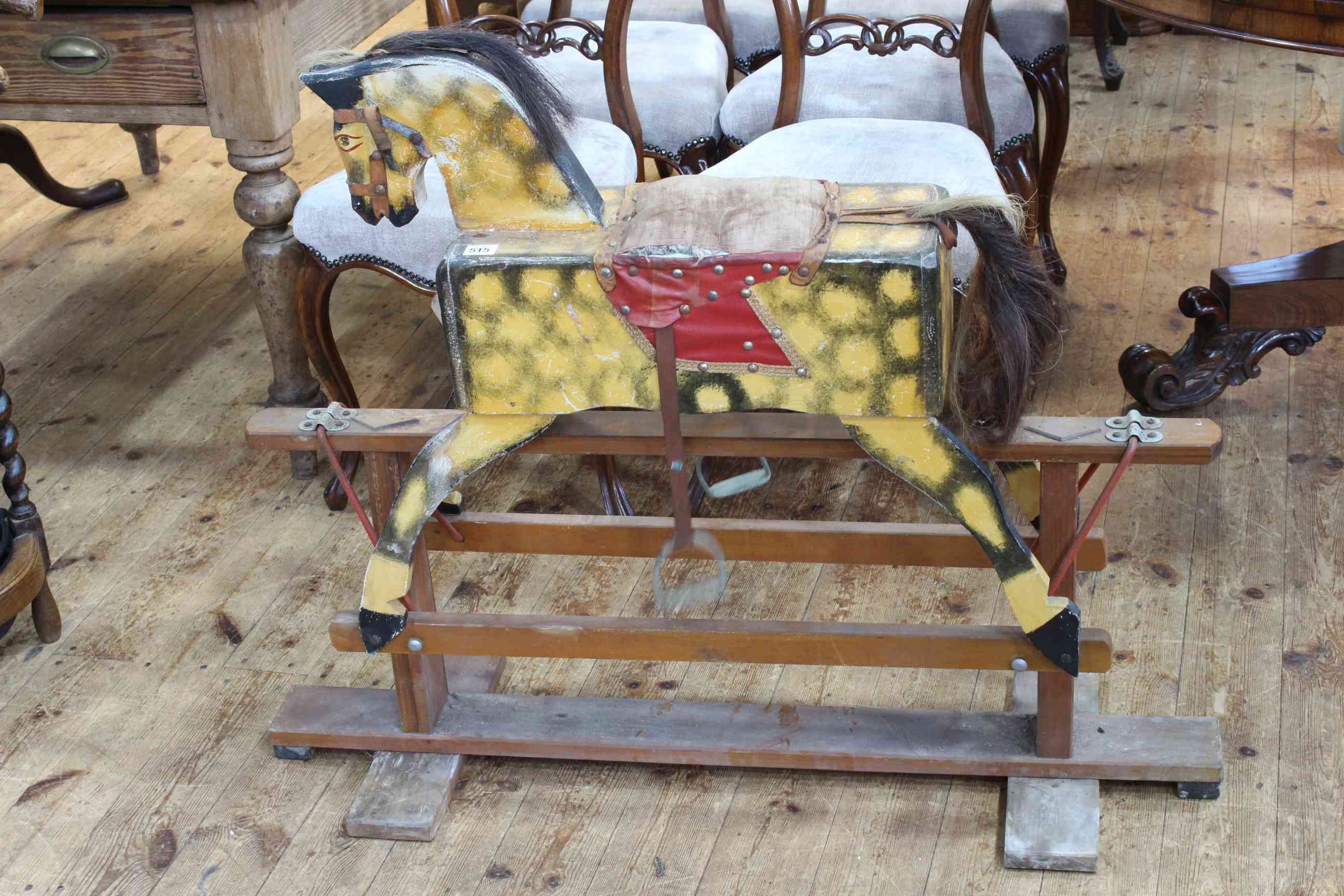 Sponge painted rocking horse on safety stand, 84cm by 106cm.