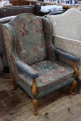 Tapestry wing open armchair on cabriole legs.