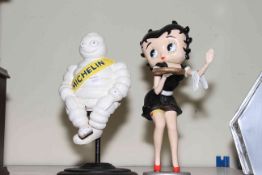 Two cast figures of Michelin Man and Betty Boop.