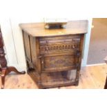 Oak canted corner hall cupboard having two drawers with carved panel cupboard door below,