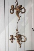 Pair of ornate two branch wall sconces.