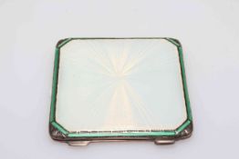 Asprey's silver and guilloché enamel compact in white enamel with green line border,
