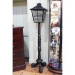 Lantern topped ebonised turned and carved triform lamp.