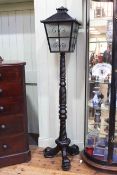 Lantern topped ebonised turned and carved triform lamp.