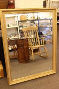 Rectangular gilt framed bevelled wall mirror, 136cm by 105cm.