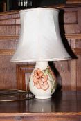 Moorcroft Pottery table lamp decorated with hibiscus on ivory ground.