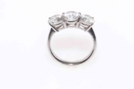 Diamond trilogy 18 carat white gold ring, the three stones total approximately 3 carat, size L.