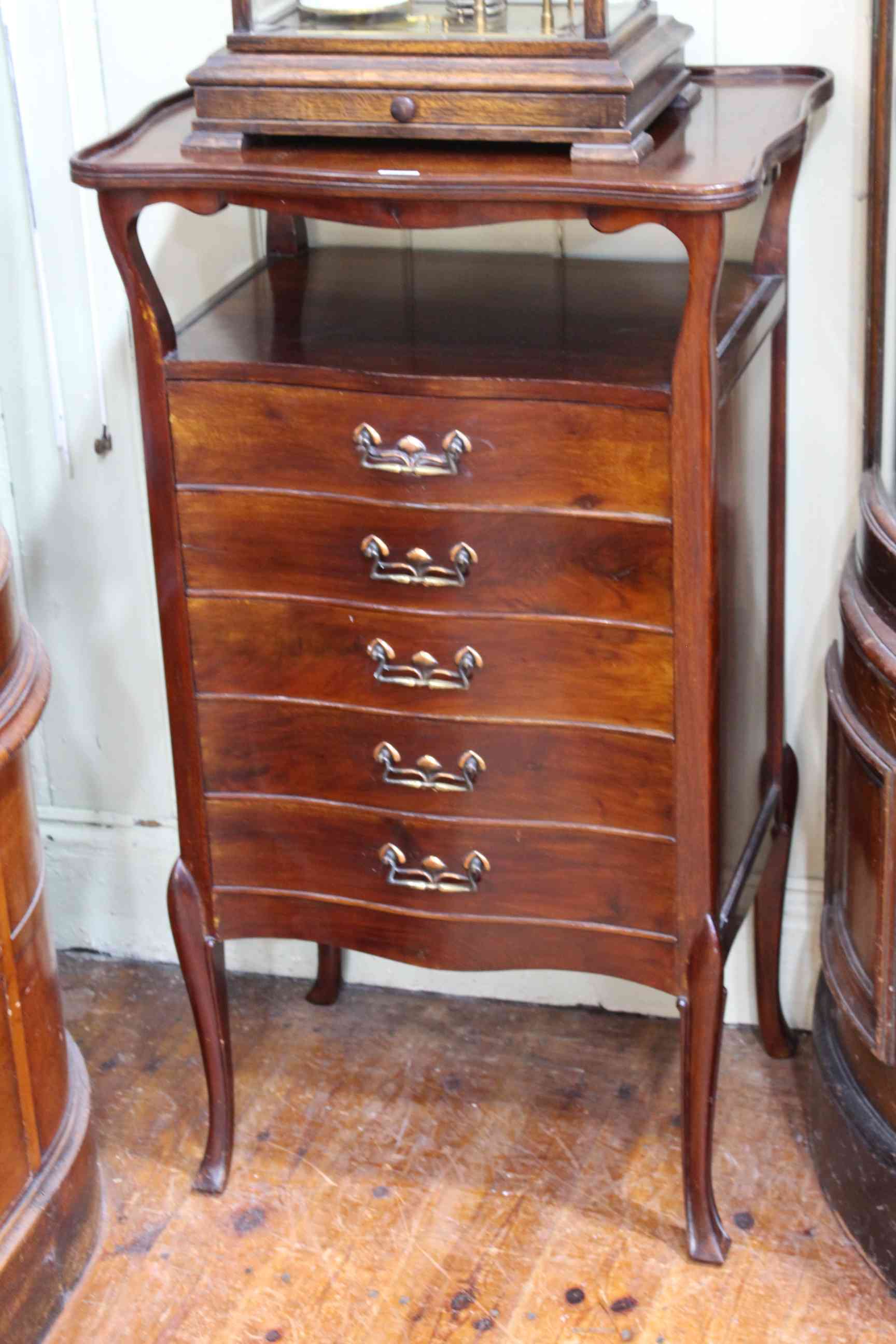 Art Nouveau mahogany five drawer music cabinet of serpentine form, 98cm by 56cm by 41cm.