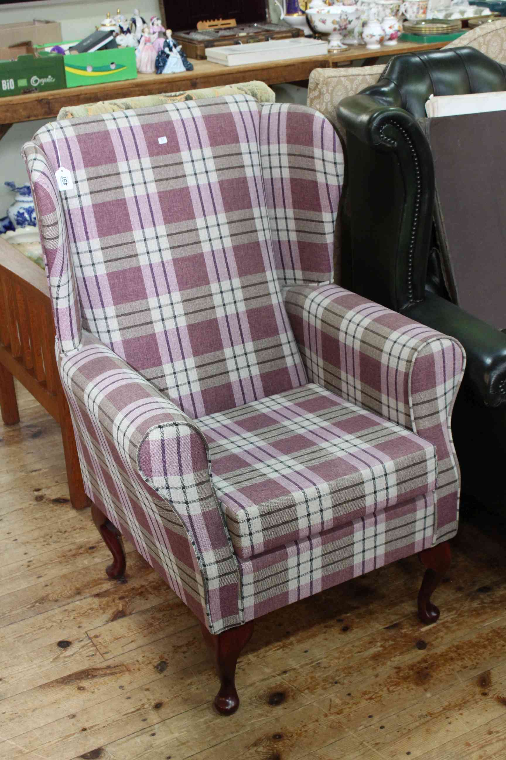 Little used wing armchair in mauve tartan fabric.