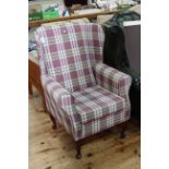 Little used wing armchair in mauve tartan fabric.