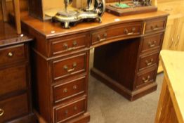 Mahogany inverted bow front nine drawer pedestal desk, 77cm by 117cm by 58.5cm.