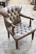 Buttoned leather library chair on reeded legs in coffee leather.