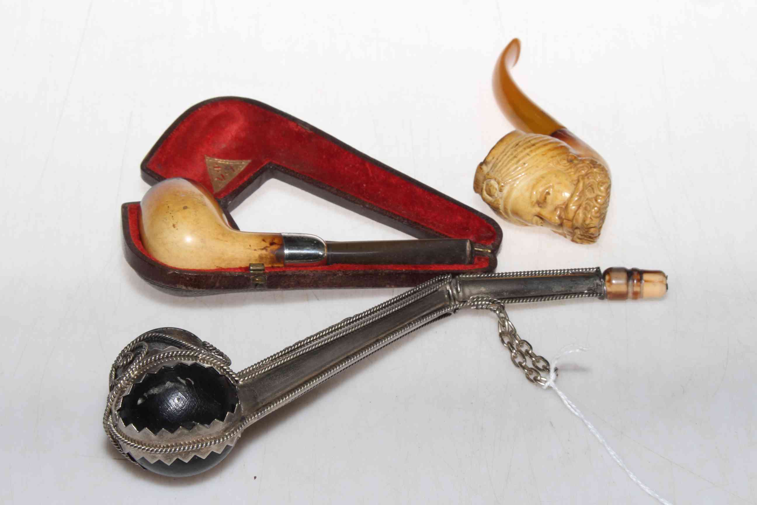 Silver mounted cased pipe Birmingham 1907, carved meerschaum pipe, and white metal pipe (3).