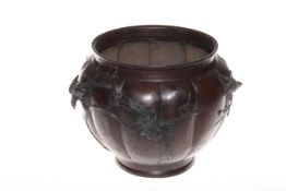 Oriental bronze jardiniere with raised bird and floral decoration, 22cm high.