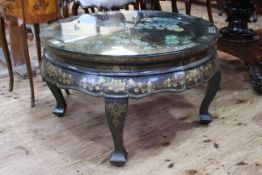 Circular black and gilt lacquered Oriental coffee table with applied decoration,