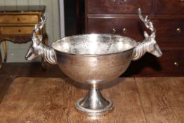 Large silvered metal pedestal punch bowl with twin stags head mount, 45cm high.