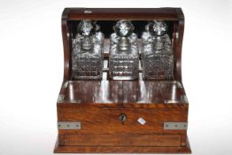 Oak three bottle tantalus with silver plated mounts,