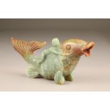 Early 20th century carved soap stone figure of a boy on the back of a large carp. 13.5cm high,