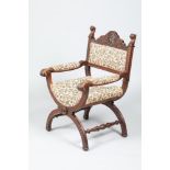 Carved oak x framed open armchair, 94cm high.