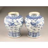 Pair 19th century blue and white Chinese vases, baluster form, decorated with dragons amongst