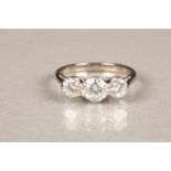 18 carat white gold three stone diamond ring, central 0.75 carat brilliant cut diamond, flanked