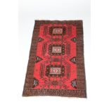 Persian rug, dark blue border with pink/red field with geometric pattern, 89cm wide, 140cm long.