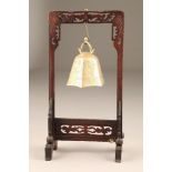 20th century carved hardwood stand with suspending brass bell, 40cm high.