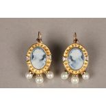 Pair 14 carat gold cameo earrings, carved oval blue cameo with a set ruby to the top, a diamond to