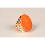 9 carat gold seal ring, pierced shoulders set with an oval orange hardstone tablet. Ring size P.