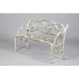 A Victorian cast iron garden seat, in the form of oak leaves and branches, 130cm long, 58cm deep,