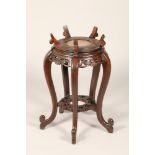 Chinese hardwood jardinière stand, circular top with supporting arms, rouge marble insert, supported