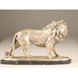 Reproduction silvered bronze figure of a male lion, mounted to a black marble base, 50cm long,