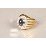 Gents sapphire and diamond ring, central cabochon sapphire surrounded by fourteen round brilliant