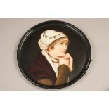 Pair of hand painted German porcelain plaques, each circular plaque depicts a woman portrayed from
