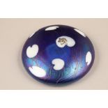 John Ditchfield for Glasform, a purple iridescent glass lily pad paperweight, mounted with a