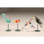 Four assorted Swarovski coloured glass birds, with stands and original boxes.