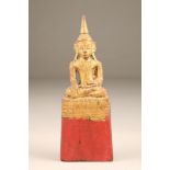 Gilt carved hardwood figure of a Tibetan buddha, 26cm high.