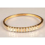 18 carat gold stiff bangle, set with twenty four 0.1 carat brilliant cut diamonds, approximate total