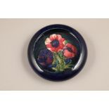 Moorcroft pottery trinket dish/shallow bowl decorated in anemone design on blue ground, incised