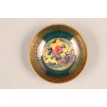 A small Wedgwood lustre circular dish, depicting a Geisha girl on green ground, No 25494, diameter