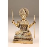 Gilt bronze figure of a Buddhist figure Manjushri, holding a sword and a staff, seated, raised on