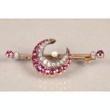 Diamond and ruby crescent brooch, set with thirteen old cut graduated diamonds and bordered with