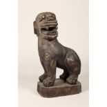 Large hardwood carving of a Chinese buddhist dog, 85cm high.