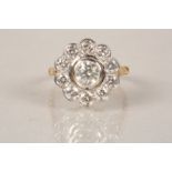 18 carat gold diamond cluster ring, daisy form, centre stone approx. 0.75 carat brilliant cut