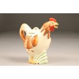 A Clarice Cliff teapot, in the form of a cockerel, height 19.5cm.