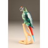 A Swarovski coloured glass parrot on stand, with original box, 23cm high.