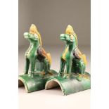 Pair of Chinese roof tiles in the form of heavenly horses in green, brown and yellow glaze, 24.5cm