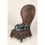 Pair 19th/20th century carved hardwood Burmese chairs, profusely carved all over with carved fret